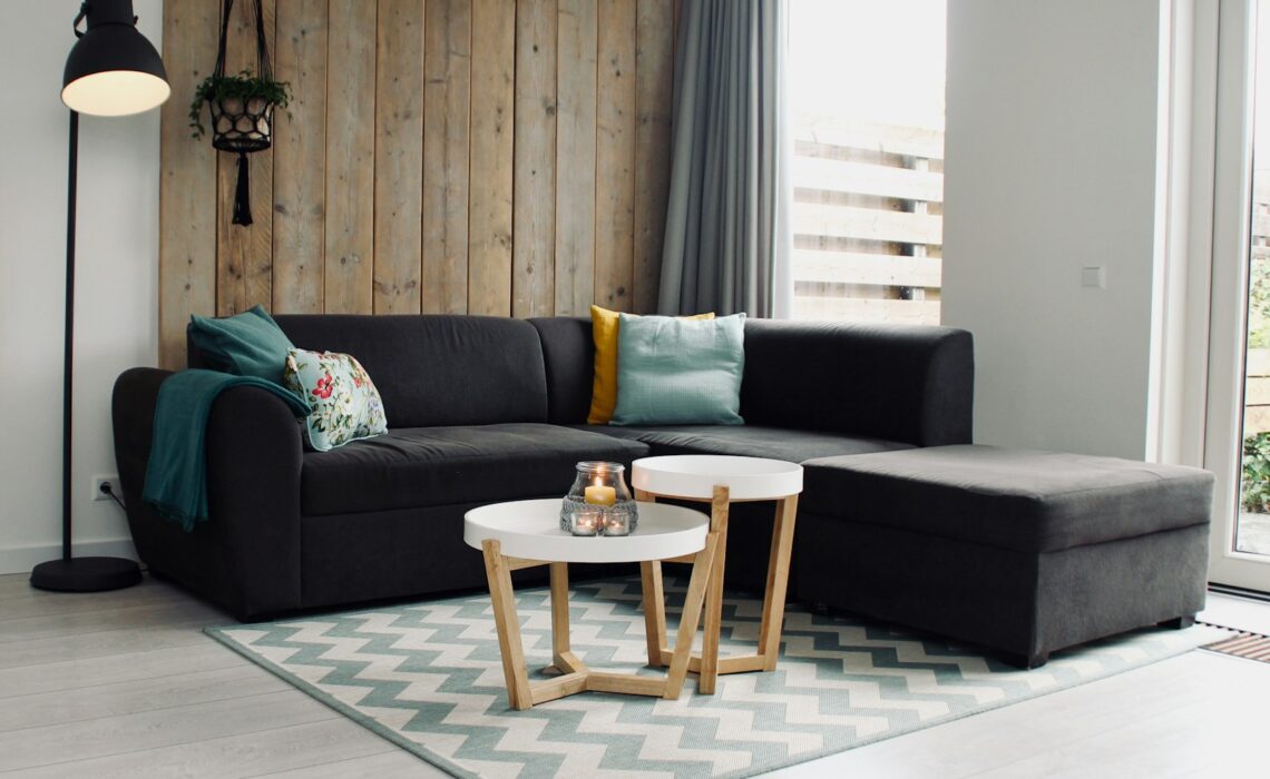 light candle on round white coffee table and sectional sofa